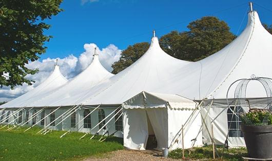 a line of portable restrooms in a shaded area, offering a comfortable experience for users in Camby